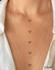 A close-up of a person's neck and upper chest wearing layered yellow gold twisted rope chain necklaces at different lengths, with printed size labels reading 16", 18", 20", 22", 24" and 0.8mm.