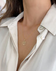 Model wearing a 10K or 14K yellow gold Tree of Life pendant necklace with a twisted rope chain.