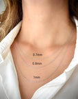 Three 14k white solid gold rope chain necklaces of different thicknesses — 0.7 mm, 0.8 mm, and 1 mm — displayed on a person's neck.