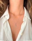 Model wearing a 10K or 14K white gold cross pendant necklace with a matching white gold rope chain.
