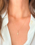14K Gold 0.8mm rope chain necklace with a cross pendant on a person wearing a white shirt.