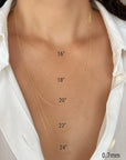 A close-up of a person's neck and upper chest wearing layered yellow gold twisted rope chain necklaces at different lengths, with printed size labels reading 16", 18", 20", 22", 24" and 0.7mm.