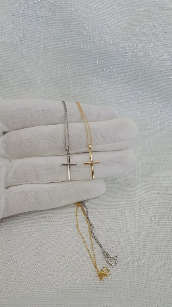 Video showing 10K or 14K yellow and white gold classic cross pendant necklaces with matching twisted rope chains with spring ring clasps displayed on a white-gloved hand.